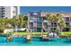 Stunning exterior of canal-front townhome with dock, solar panels, balconies and well-manicured lawn at 101 Marina Del Rey Ct, Clearwater, FL 33767