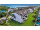 Exterior view of a multi-story townhome with balconies, stairs, green grass, and canal in the rear at 101 Marina Del Rey Ct, Clearwater, FL 33767