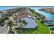 Exterior shot of canal-front property with solar panels, lush green lawn, and dock access at 101 Marina Del Rey Ct, Clearwater, FL 33767