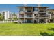 Multi-story condominium with spiral staircases and lush green lawn at 101 Marina Del Rey Ct, Clearwater, FL 33767
