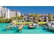 Exterior image of canal-front townhome with dock, solar panels, lush landscaping and clear water views at 101 Marina Del Rey Ct, Clearwater, FL 33767