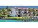 Waterfront condo featuring a private dock, balconies, and lush landscaping, perfect for enjoying coastal living at 101 Marina Del Rey Ct, Clearwater, FL 33767