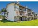 Condominium featuring spiral staircases and multiple balconies, surrounded by green lawn at 101 Marina Del Rey Ct, Clearwater, FL 33767