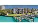 Exterior photo showing canal-front townhome, private boat dock, solar panels, and lush lawn at 101 Marina Del Rey Ct, Clearwater, FL 33767
