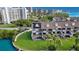 View of townhome with spiral staircase, canal, lawn, dock, and solar panels at 101 Marina Del Rey Ct, Clearwater, FL 33767