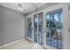 Elegant foyer with decorative glass doors, complemented by neutral wall colors and tile flooring at 101 Marina Del Rey Ct, Clearwater, FL 33767
