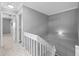 Hallway with neutral walls, carpet flooring, and white stair railing at 101 Marina Del Rey Ct, Clearwater, FL 33767