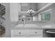 View of kitchen with double basin sink and stainless steel dishwasher, with a partial view of living area at 101 Marina Del Rey Ct, Clearwater, FL 33767