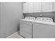 Laundry room features a washer, dryer, and white cabinets for storage at 101 Marina Del Rey Ct, Clearwater, FL 33767