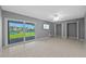 Bright living room with water views, tile flooring, ceiling fan, and sliding glass doors at 101 Marina Del Rey Ct, Clearwater, FL 33767