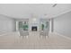 Bright living room featuring a cozy fireplace, tile flooring, and sliding glass doors to outdoor views at 101 Marina Del Rey Ct, Clearwater, FL 33767