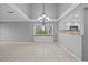 Open-concept living room featuring tile flooring, chandelier lighting, and a view of the adjacent kitchen at 101 Marina Del Rey Ct, Clearwater, FL 33767