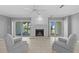 Cozy living room featuring a fireplace, tile flooring, and sliding doors offering serene outdoor views at 101 Marina Del Rey Ct, Clearwater, FL 33767