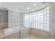 Luxurious main bathroom featuring a separate jacuzzi tub and a glass block shower at 101 Marina Del Rey Ct, Clearwater, FL 33767
