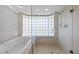 Luxurious main bathroom featuring a jacuzzi tub and a glass block shower at 101 Marina Del Rey Ct, Clearwater, FL 33767