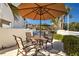 Outdoor patio with a round table, four chairs, and an umbrella, perfect for relaxing by the pool at 101 Marina Del Rey Ct, Clearwater, FL 33767