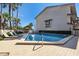 Community pool surrounded by lounge chairs and palm trees on a sunny day at 101 Marina Del Rey Ct, Clearwater, FL 33767