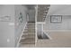 Carpeted staircase with white banister and tiled landing leads to the upper level of this well-maintained home at 101 Marina Del Rey Ct, Clearwater, FL 33767