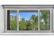 Bright window with an exterior view of neighboring buildings and palm trees at 101 Marina Del Rey Ct, Clearwater, FL 33767