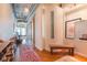 Hallway featuring a stylish bench, modern art, and exposed industrial ceilings at 101 N 12Th St # 400, Tampa, FL 33602