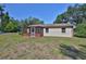 Cozy home featuring a screened-in porch and ample yard space, perfect for outdoor enjoyment at 1019 Lakeside Dr, Seffner, FL 33584