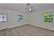 Bright bedroom featuring neutral carpet and natural light from bright windows at 1019 Lakeside Dr, Seffner, FL 33584