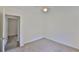 Bright bedroom featuring neutral carpet, natural light, and doorway at 1019 Lakeside Dr, Seffner, FL 33584