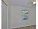 Bedroom featuring wood-look flooring, closet, and bright window view at 1019 Lakeside Dr, Seffner, FL 33584