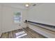 Bedroom featuring wood-look flooring, window views, and an extended black countertop at 1019 Lakeside Dr, Seffner, FL 33584