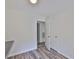 Bright bedroom featuring wood-look tile, neutral paint, and natural light at 1019 Lakeside Dr, Seffner, FL 33584