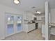 Bright kitchen featuring white cabinetry, modern appliances, and tile flooring at 1019 Lakeside Dr, Seffner, FL 33584