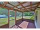 Screened porch showcasing overhead wood beams, screen, and lawn views at 1019 Lakeside Dr, Seffner, FL 33584