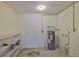 Utility room with water heater, shelving, and basic fixtures at 1019 Lakeside Dr, Seffner, FL 33584