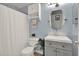 Bright bathroom with a white shower curtain and a vanity with storage at 10265 Gandy N Blvd # 906, St Petersburg, FL 33702