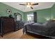 Comfortable bedroom featuring wood floors, ceiling fan, large dresser, and natural light at 10265 Gandy N Blvd # 906, St Petersburg, FL 33702