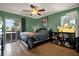 Bedroom boasting wood floor, sliding glass doors to a balcony, aquarium, and neutral decor at 10265 Gandy N Blvd # 906, St Petersburg, FL 33702