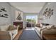 Cozy living room with a fireplace, stylish decor, and access to outdoor space at 10265 Gandy N Blvd # 906, St Petersburg, FL 33702