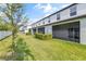 Backyard view of enclosed lanais, green grass, and a white fence at 10472 Shady Preserve Dr, Riverview, FL 33578