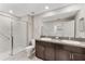 Bright bathroom featuring a double vanity and glass enclosed shower at 10472 Shady Preserve Dr, Riverview, FL 33578