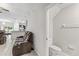 Living room showcasing a half bathroom with tiled floor and traditional decor at 10472 Shady Preserve Dr, Riverview, FL 33578