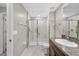 Well-lit bathroom featuring a glass enclosed shower and a granite vanity at 10472 Shady Preserve Dr, Riverview, FL 33578