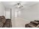 Spacious bonus room with tile flooring, neutral walls, and comfortable seating arrangement at 10472 Shady Preserve Dr, Riverview, FL 33578