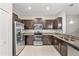 Modern kitchen featuring stainless steel appliances, granite countertops, tile backsplash, and ample cabinet space at 10472 Shady Preserve Dr, Riverview, FL 33578