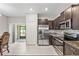 Well-equipped kitchen with stainless steel appliances, granite countertops, and seamless access to a covered patio at 10472 Shady Preserve Dr, Riverview, FL 33578