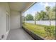 Relaxing enclosed lanai overlooking a green backyard and white fence at 10472 Shady Preserve Dr, Riverview, FL 33578