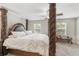 The main bedroom suite has ornate four poster bed and natural light at 10472 Shady Preserve Dr, Riverview, FL 33578