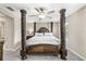 Comfortable main bedroom with detailed wood column bedframe and carpet at 10472 Shady Preserve Dr, Riverview, FL 33578