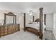 Spacious main bedroom features detailed wood column bedframe and matching furniture at 10472 Shady Preserve Dr, Riverview, FL 33578