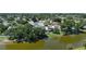 A pond view with a house, trees, and a serene neighborhood in the background at 10775 Glen Ellen Dr, Tampa, FL 33624