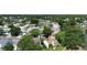 An aerial view of a neighborhood with a pond, houses, and green trees at 10775 Glen Ellen Dr, Tampa, FL 33624